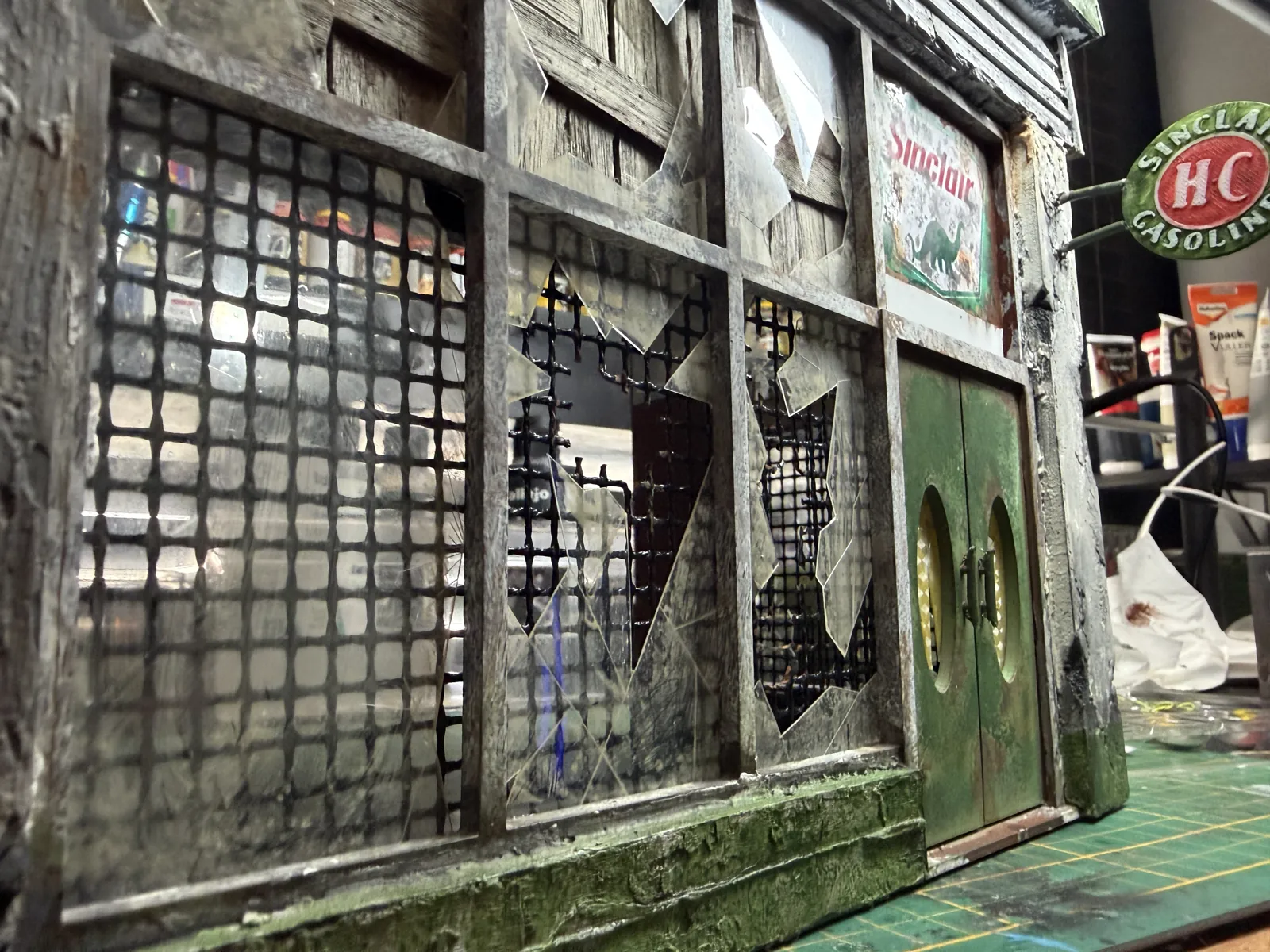 Close-up of the front windows with broken glass and mesh behind it