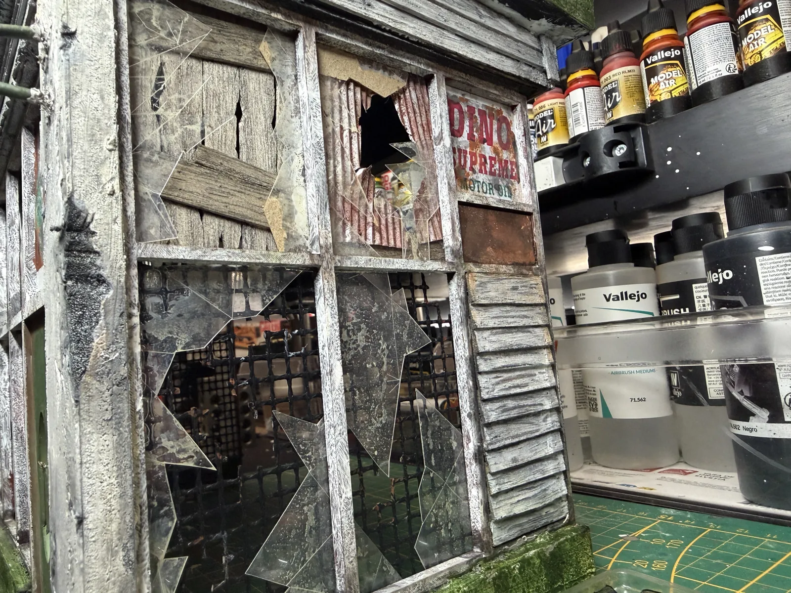 Close-up of the broken windows and peeling clapboard